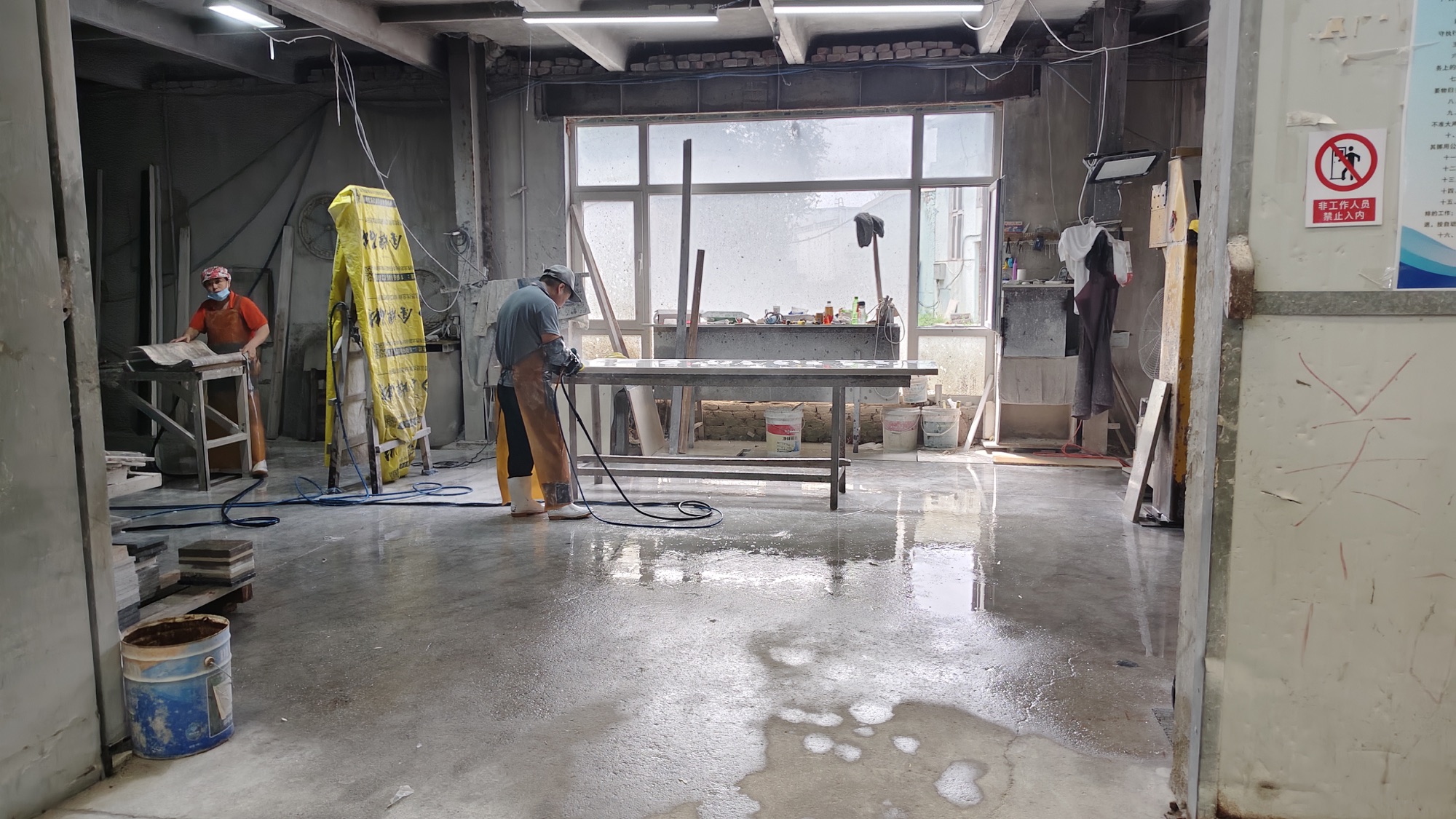 Stone fabricators hand-finishing and polishing work in Harbour's factory